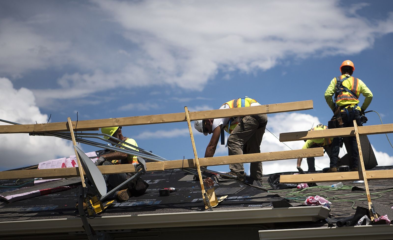 The Vega Roofing crew going over the day's job on a driveway in Cicero