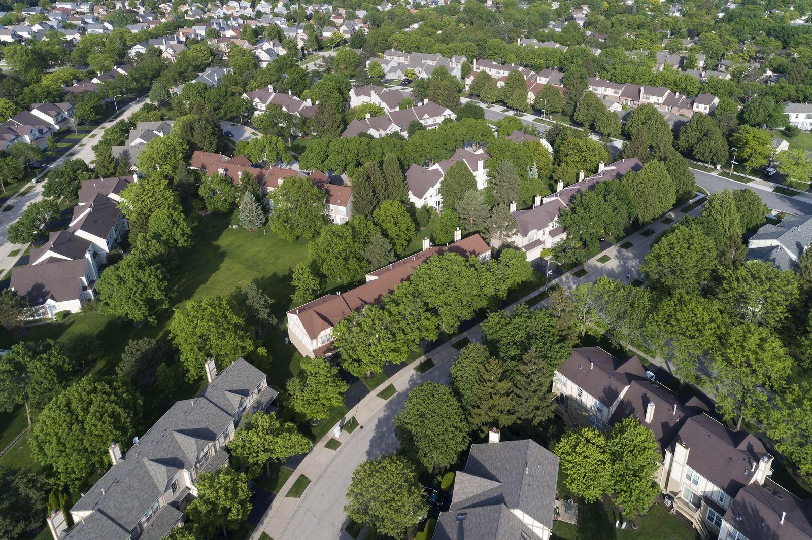 Roofers working on a row of attached homes